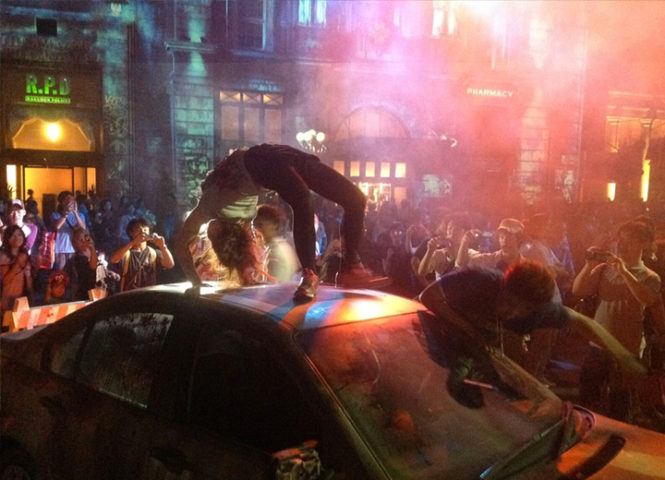 A performer flipping on top of a car from the Biohazard Resident Evil show from Universal Studios Japan