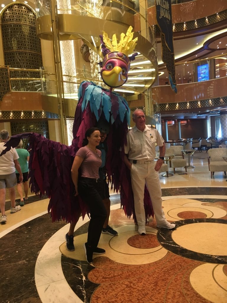 Two people standing next to a performer in a "Crazy Birds" kinetic puppet costume.